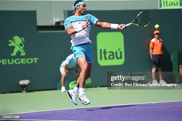 Rafael Nadal of Spain returns a shot to Damir Dzumhur of Bosnia and Herzegovina during the Miami Open presented by Itau at Crandon Park Tennis Center...