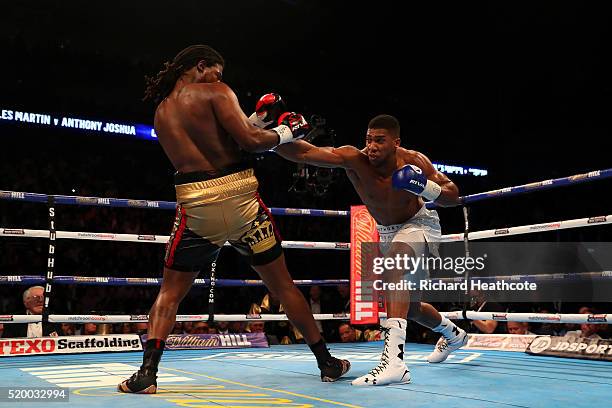 Anthony Joshua of England lands a punch on Charles Martin of the United States during the IBF World Heavyweight title fight at The O2 Arena on April...