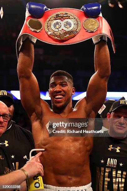 Anthony Joshua of England celebrates with the belt after defeating Charles Martin of the United States in action during the IBF World Heavyweight...