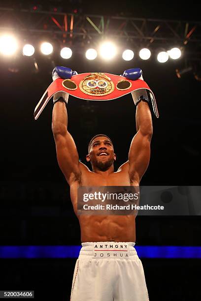 Anthony Joshua of England celebrates with the belt after defeating Charles Martin of the United States in action during the IBF World Heavyweight...