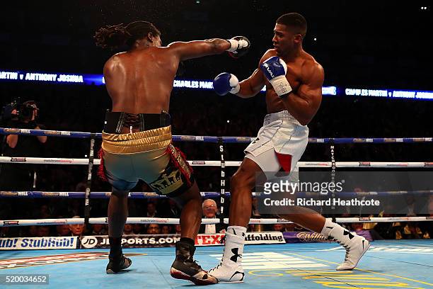 Anthony Joshua of England knocks Charles Martin of the United States to the canvas during the IBF World Heavyweight title fight at The O2 Arena on...