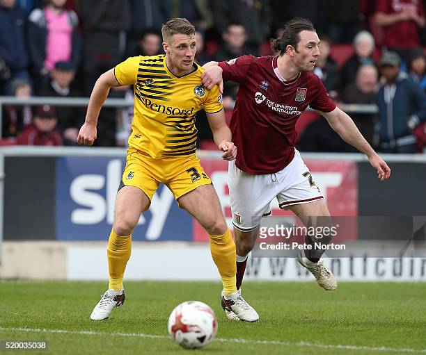 John-Joe O'Toole of Northampton Town and Lee Brown of Bristol Rovers challenge for the ball during the Sky Bet League Two match between Northampton...