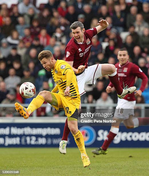 Zander Diamond of Northampton Town and Matty Taylor of Bristol Rovers contest the ball during the Sky Bet League Two match between Northampton Town...