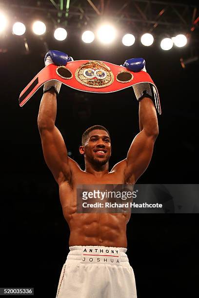 Anthony Joshua of England celebrates with the belt after defeating Charles Martin of the United States in action during the IBF World Heavyweight...