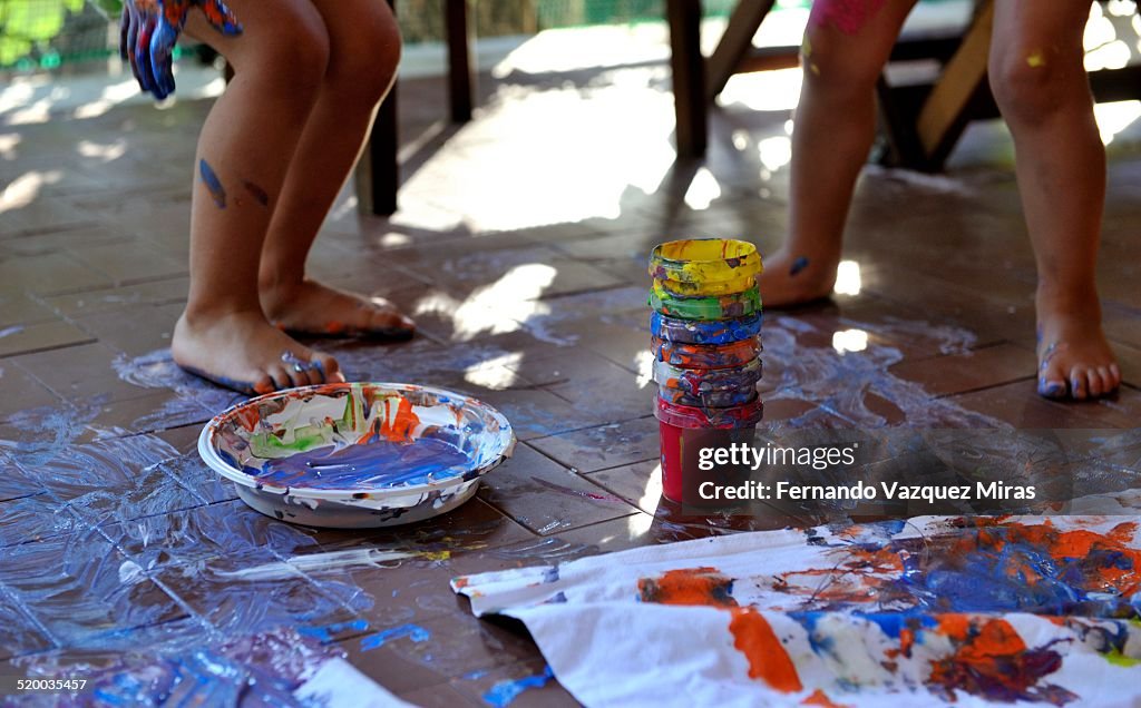 Kids painting in the floor
