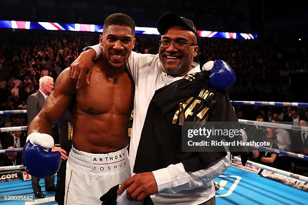 Anthony Joshua of England celebrates with his father Jonathan after defeating Charles Martin of the United States in action during the IBF World...