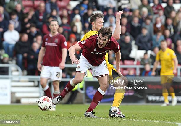 John Marquis of Northampton Town attempts to move away with the ball under pressure from Ollie Clarke of Bristol Rovers during the Sky Bet League Two...