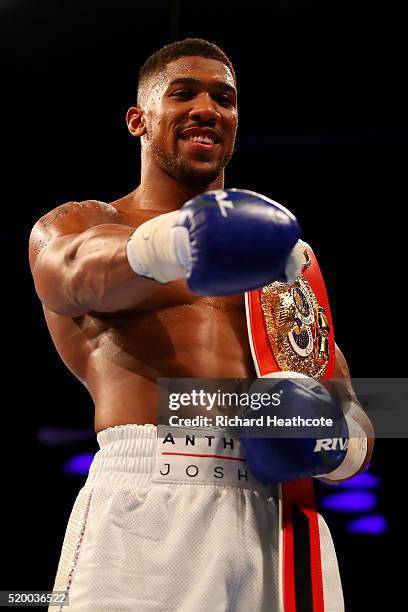 Anthony Joshua of England celebrates with the belt after defeating Charles Martin of the United States in action during the IBF World Heavyweight...