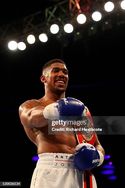 Anthony Joshua of England celebrates with the belt after defeating Charles Martin of the United States in action during the IBF World Heavyweight...