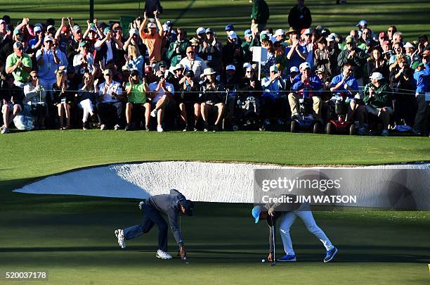 Golfer Jordan Spieth and Northern Ireland's Rory McIlroy mark their balls during Round 3 of the 80th Masters Golf Tournament at the Augusta National...