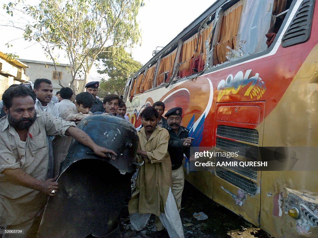 Pakistani volunteers remove the debris o