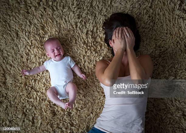 gestresste mutter und ihr baby - familie anonym stock-fotos und bilder