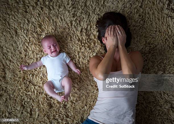 stressed mother and her baby - mom head in hands stock pictures, royalty-free photos & images