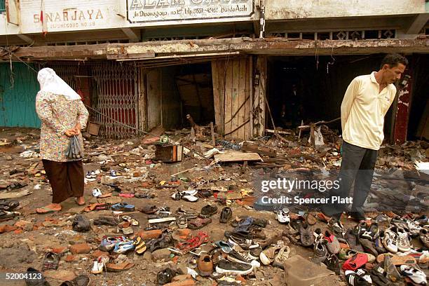 People look through the remains of shops on a street devastated in the tsunami January 16, 2005 in Banda Aceh, Indonesia. The province of Aceh, one...