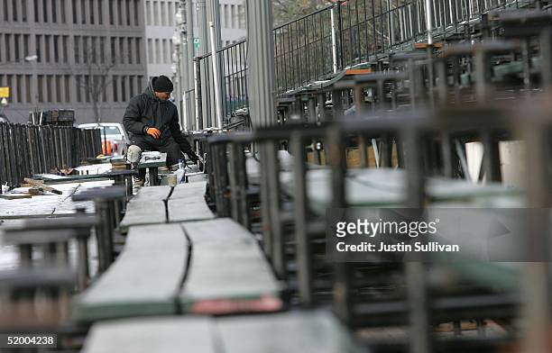 Worker builds bleacher seating next to the Inaugural Parade viewing stand in front of The White House January 17, 2005 in Washington, DC. U.S....