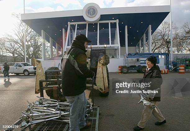 Workers move lighting equipment at the Inaugural Parade viewing stand in front of The White House January 17, 2005 in Washington, DC. U.S. President...