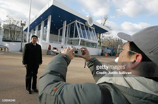 Man has his picture taken in front of the Inaugural Parade viewing stand at The White House January 17, 2005 in Washington, DC. U.S. President George...