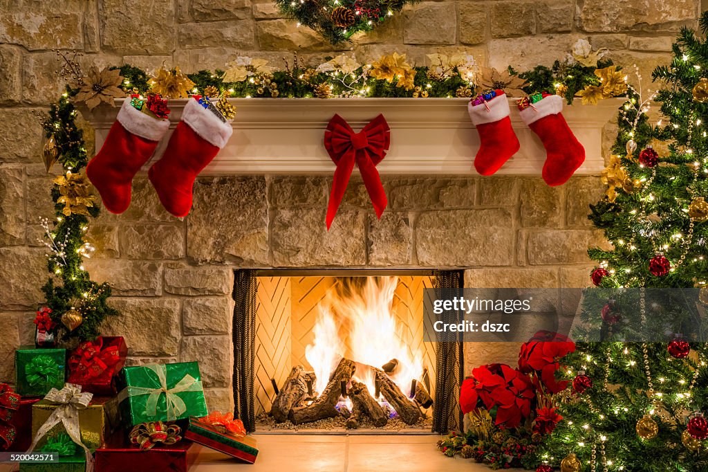 Christmas fireplace, tree, stockings, fire, hearth, lights, and decorations