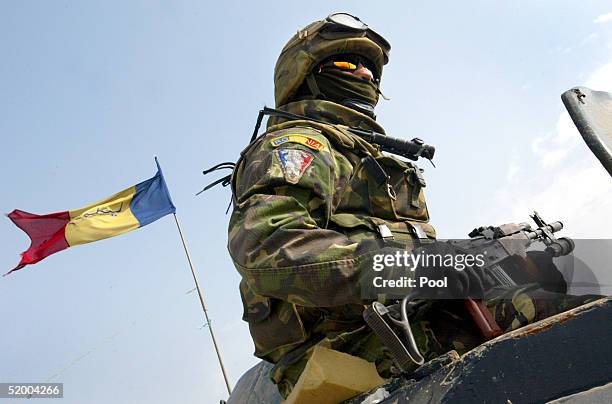 Romanian soldier sits atop his armored vehicle at a police station January 17, 2005 in Nasiriyah, Iraq. Romanian soldiers were helping to provide...