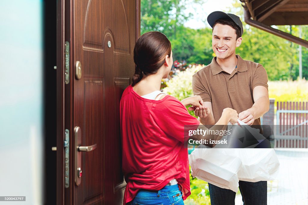 Delivery man delivering chinese take away food