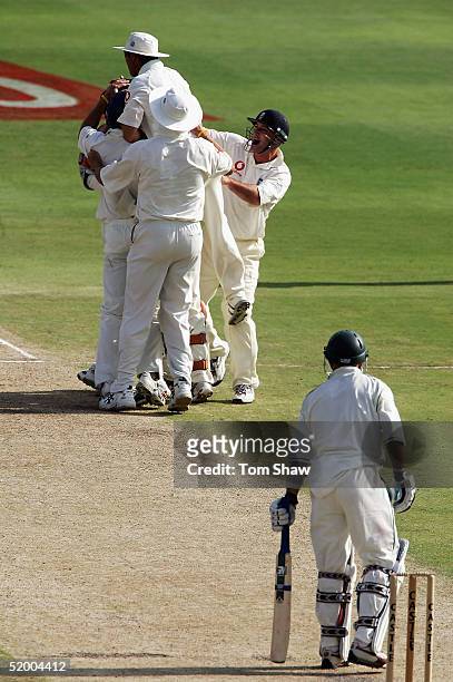 Ashley Giles of England is mobbed after taking the wicket of Herschelle Gibbs of South Africa during day five of the fourth Test between England and...