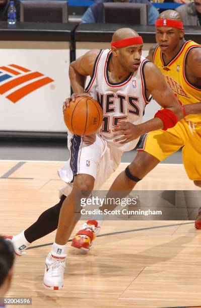 Vince Carter of the New Jersey Nets drives to the lane against Al Harrington of the Atlanta Hawks during a game on January 17, 2005 at Philips Arena...