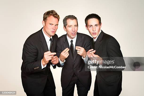 male a capella trio in suits singing and snapping - man singing stock pictures, royalty-free photos & images