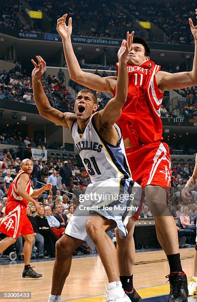 Shane Battier of the Memphis Grizzlies and Yao Ming of the Houston Rockets battle underneath on January 17, 2005 at FedexForum in Memphis, Tennessee....