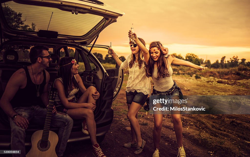 Happy hipsters on a road trip