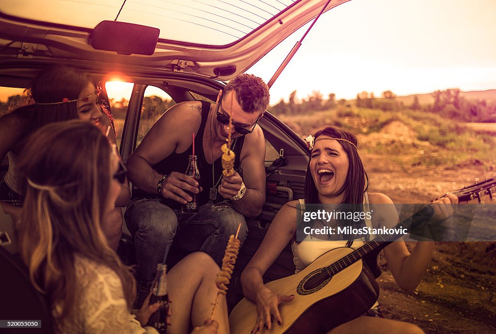 Happy hipsters on a road trip