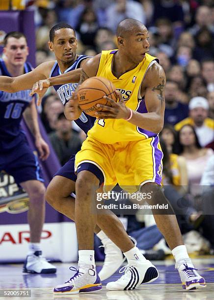 Howard Eisley of the Utah Jazz puts the pressure on Caron Butler of the Los Angeles Lakers on January 17, 2005 at Staples Center in Los Angeles,...