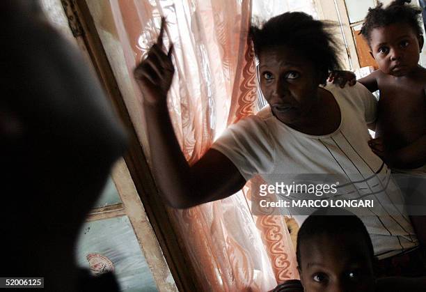 Louise Auguste shouts, 17 January 2005 at her home in Port Louis, Mauritius. The family of 9, originally from the Chagos Archipelago now live a...