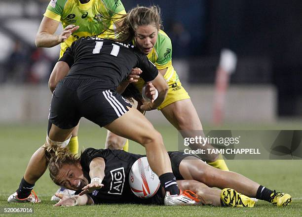 New Zealand's Niall Williams tries to hold onto the ball as teammate Portia Woodman blocks against Australia's Chloe Dalton at the final of the...