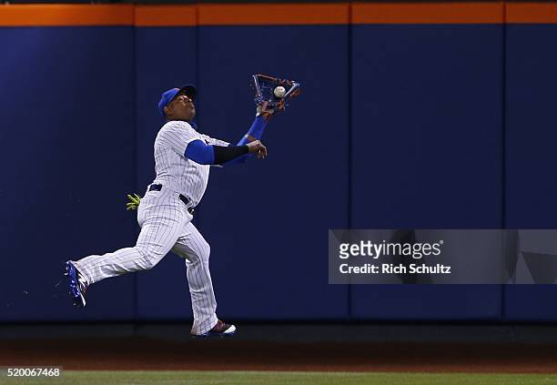 Center fielder Yoenis Cespedes of the New York Mets reaches back to make a catch on a ball hit by Peter Bourjos during the eighth inning of a game at...