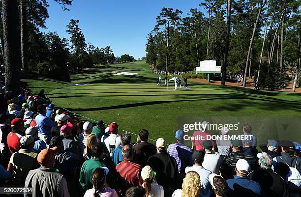 Golfer Jordan Spieth and Northern Ireland's Rory McIlroy prepare to putt to the 10th green during Round 3 of the 80th Masters Golf Tournament at the...