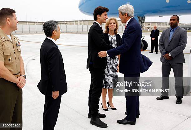 Ambassador to Japan Caroline Kennedy and her son Jack Schlossberg greet US Secretary of State John Kerry upon his arrival at Iwakuni Marine Corps Air...