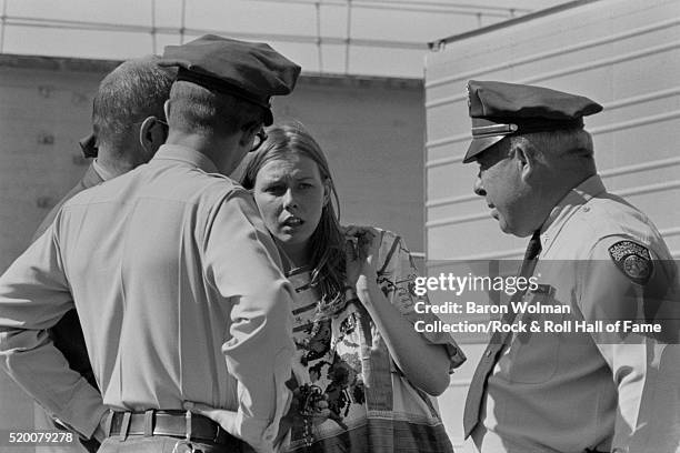 Woman talks with police officers at San Quentin prison on Bread & Roses' show, San Francisco, October 11, 1969.