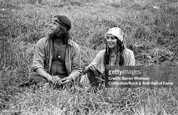 Couple rest on the grass at the Woodstock Music & Art Fair, Bethel, NY, August 15, 1969.