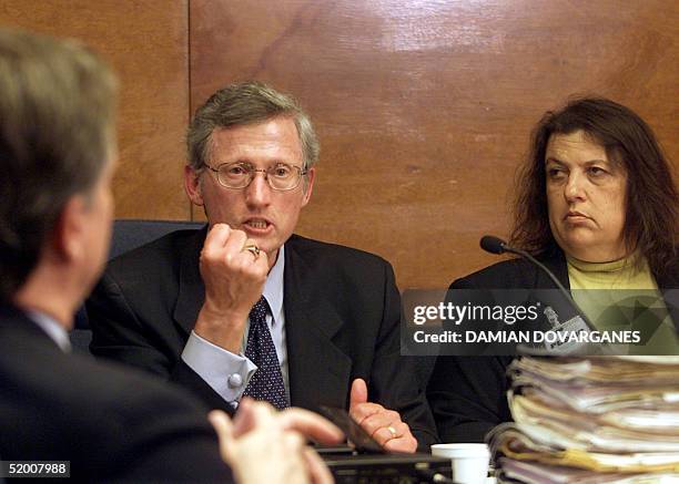 Former district attorney Stephen Kay shows how Leslie Van Houten held a knife as he addresses members of the Board of Prison Terms commissioners...