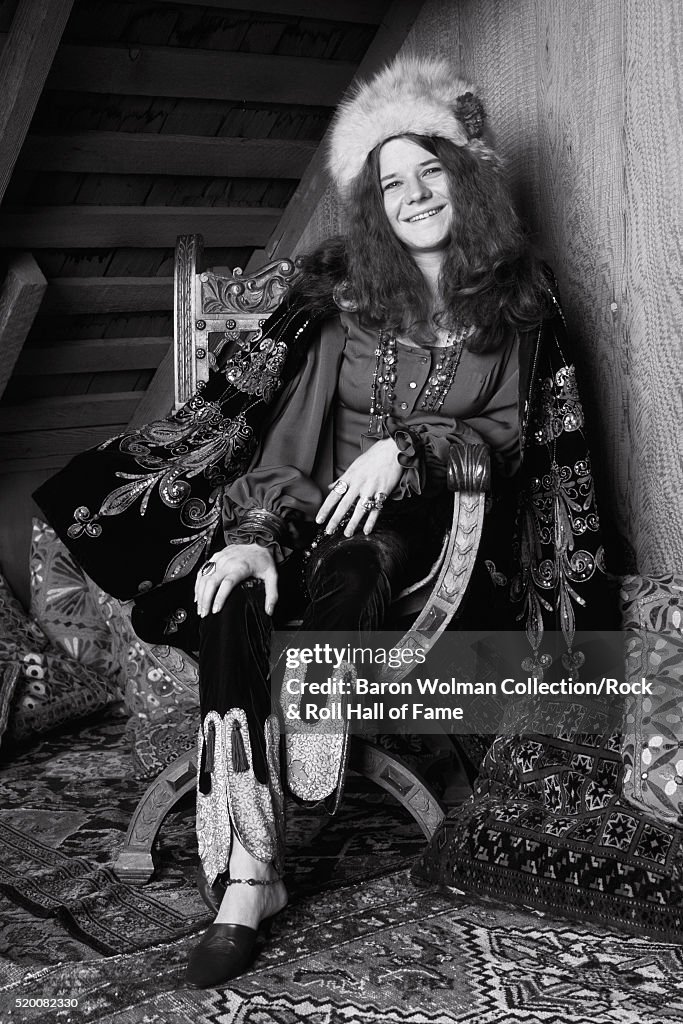 American singer Janis Joplin poses at her home in front of a Bob ...