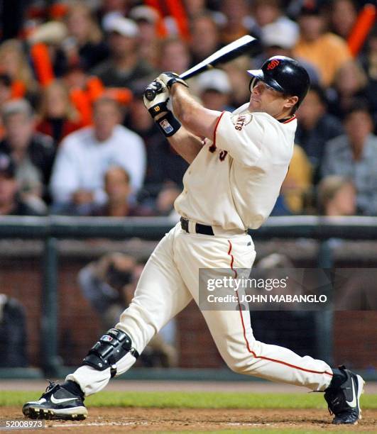 Snow of San Francisco Giants connects on a two-run double against the St. Louis Cardinals in the sixth inning during game 4 of the National League...