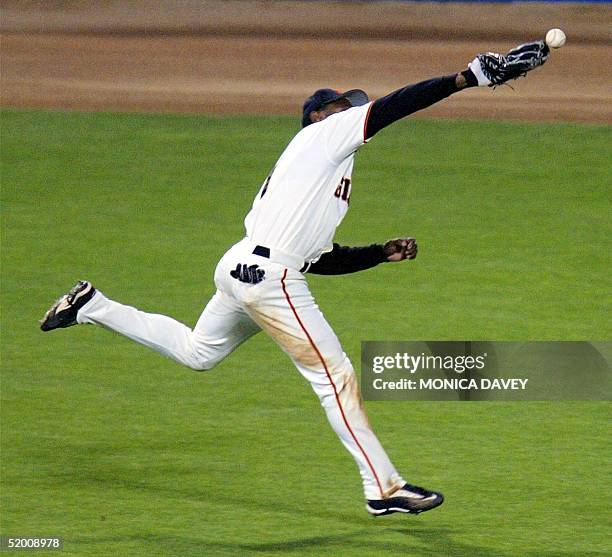 Center fielder Kenny Lofton of the San Francisco Giants misses a double hit by Mike Matheny of the St. Louis Cardinals in the seventh inning of game...