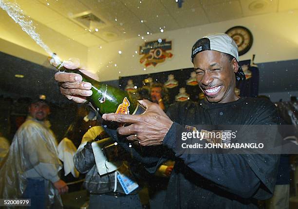 Kenny Lofton of the San Francisco Giants celebrates in the locker room after clinching the National League Championship against the St. Louis...