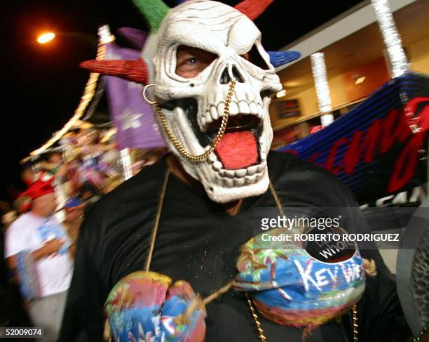 Reveler in a rather bizarre costume walks down Duval Street during the Fantasy Fest Parade late 26 October 2002 in Key West, Florida. More than...