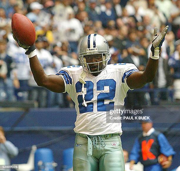 Emmitt Smith of the Dallas Cowboys celebrates the tying touchdown against the Seattle Seahawks after breaking the NFL all-time rushing record at...