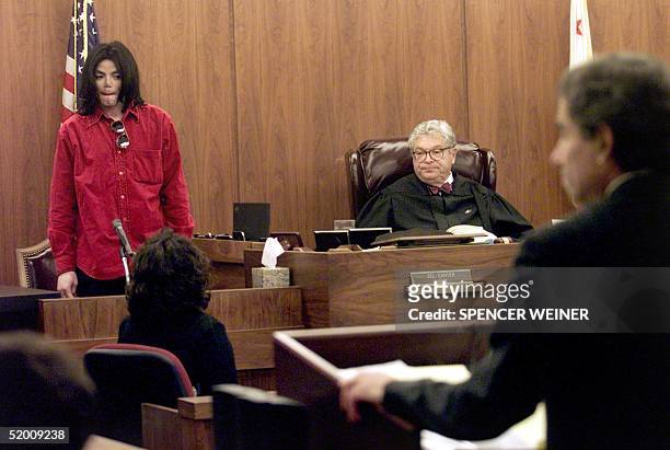 Entertainer Michael Jackson stands during court proceedings in Santa Maria Superior Court 13 November 2002, in a trial in which he is accused of...