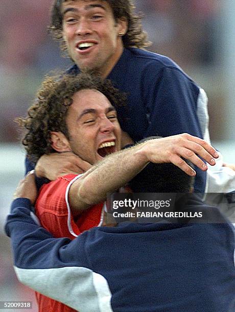 Soccer players Gabriel Milito Federico Insua , and Rodolfo Montenegro are seen celebrating their victory in Buenos Aires, Argentina 01 December 2002....