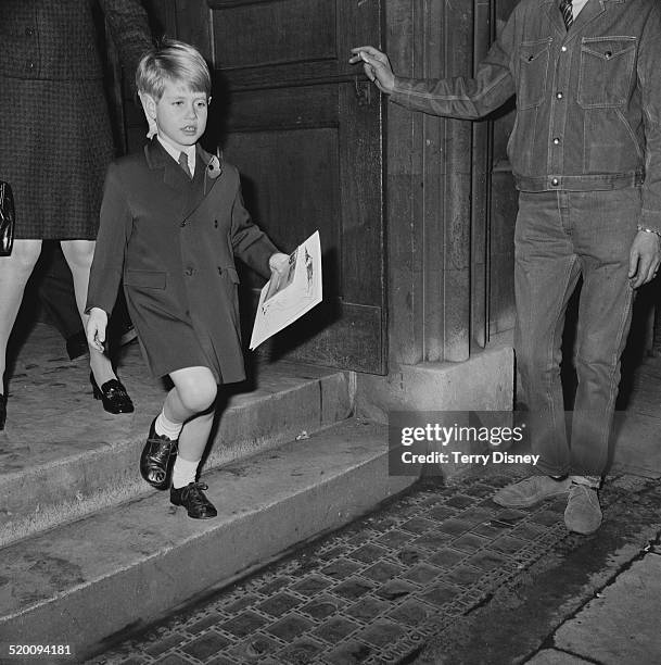 Prince Edward, closely followed by his governess, Lavinia Keppel, leaving the Children's Book Show in Westminster, London, 7th November 1969.