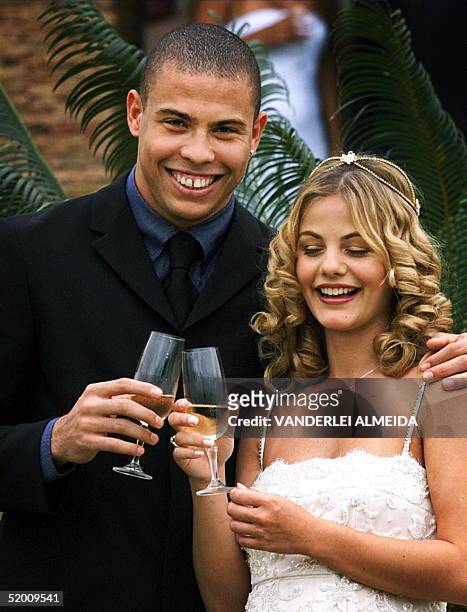 Soccer player Ronaldo is shown with his wife, Milene Domingues during their marriage 24 December 1999 in Rio de Janeiro. The couple have announced...