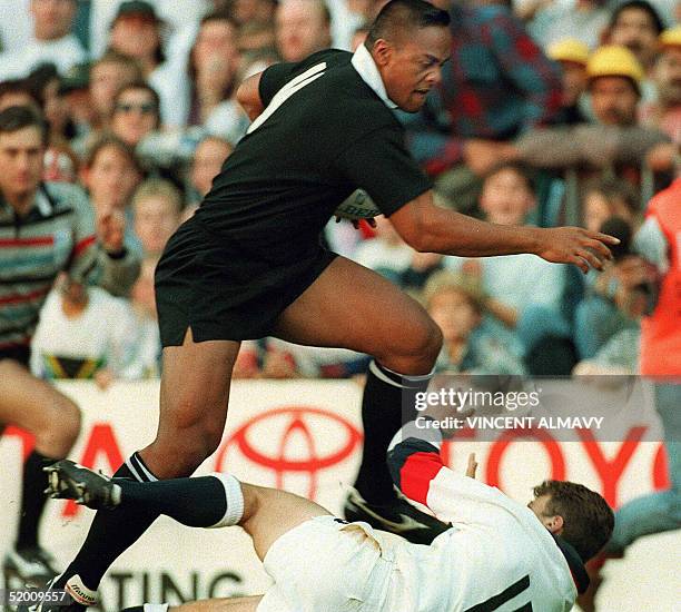 New Zealand winger Jonah Lomu runs through England's fullback Mike Catt during the Rugby World Cup semi-final match between New Zealand and England...